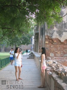 Young Women make use of the Village’s 14th century monument as a backdrop for their photographs