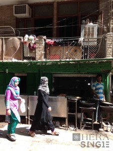 Fig. 4 A street food vendor gazing two female passers-by in Khirkee (Photo by Penn)