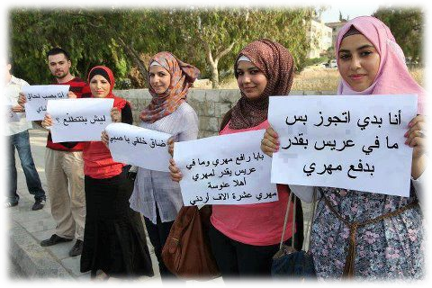 Young men and women protesting the high Mahr demands in society. The signs say "I want to get married but no groom can afford my Mahr", "My father raised my Mahr and no groom can pay it. Welcome spinsterhood, my Mahr is 10,000 Jordanian Dinars"